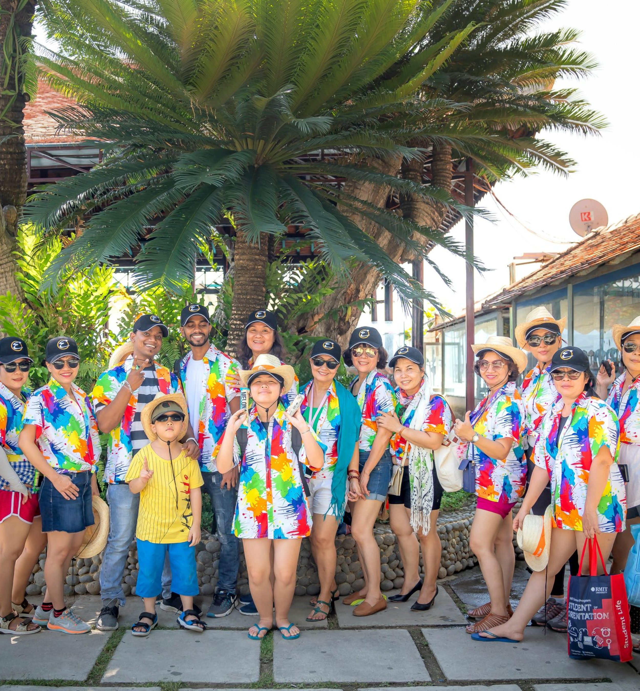 A lively group of friends dressed in colorful summer outfits enjoying a day outdoors during vacation.
